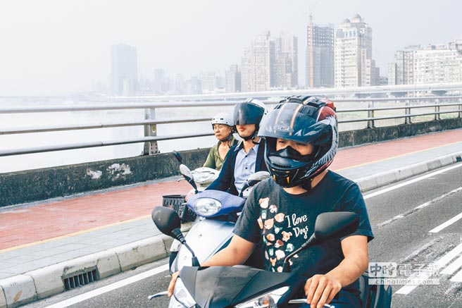 图为一位民众骑经台北市桥梁，天空雾茫茫。（《中国时报》 郭吉铨摄）